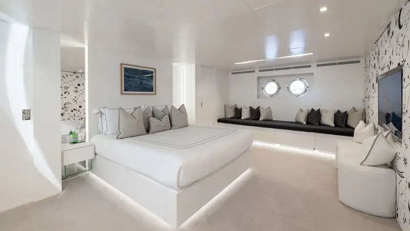 One of the four refitted guest cabins, with its own portholes, a built-in banquette and a starfield motif on the joinery - part of the systems and interior updates Fraser's listing credits ahead of the sale.