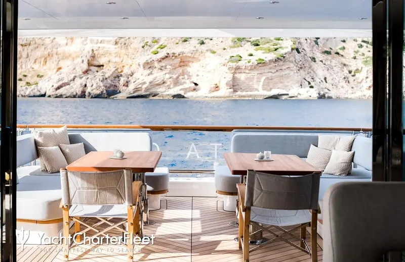 The aft deck lounge, looking out over a cove off Mallorca. Delta One returned to charter here after her sale to repeat Mulder clients.