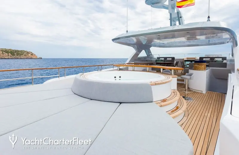 The sundeck jacuzzi and helm bar. Her under-300GT design brief was built to let a single owner-operator run her without the crew a full-tonnage yacht would demand.