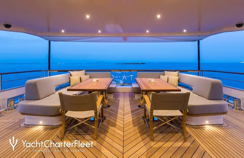 Alfresco dining at blue hour on the upper deck. Delta One's twin 1,150hp Caterpillar C18 diesels burn 73 litres an hour at 10 knots.