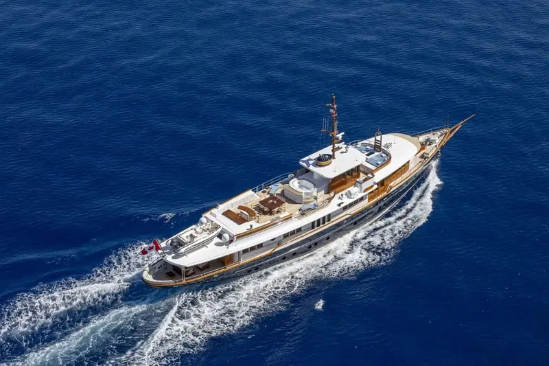 An aerial view shows the full teak deck spaces that run the length of the yacht, from the bow to the aft cockpit.
