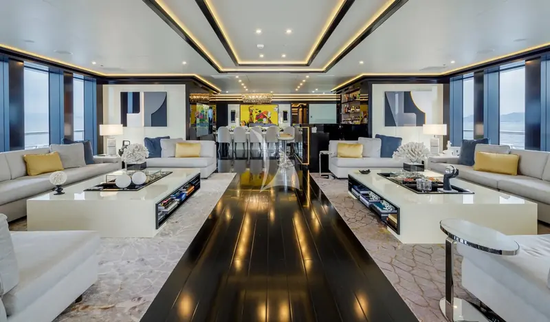 The main saloon, reworked in the 2023 refit with an earth-toned scheme and full-beam sea views.