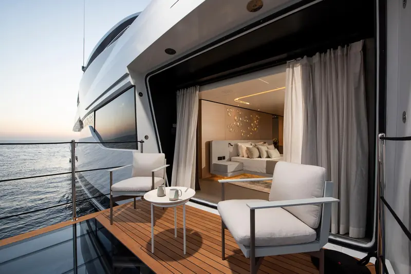 The owner's fold-down balcony, open at anchor. It turns the forward suite into an outdoor room, the feature Fraser's own listing leads with.