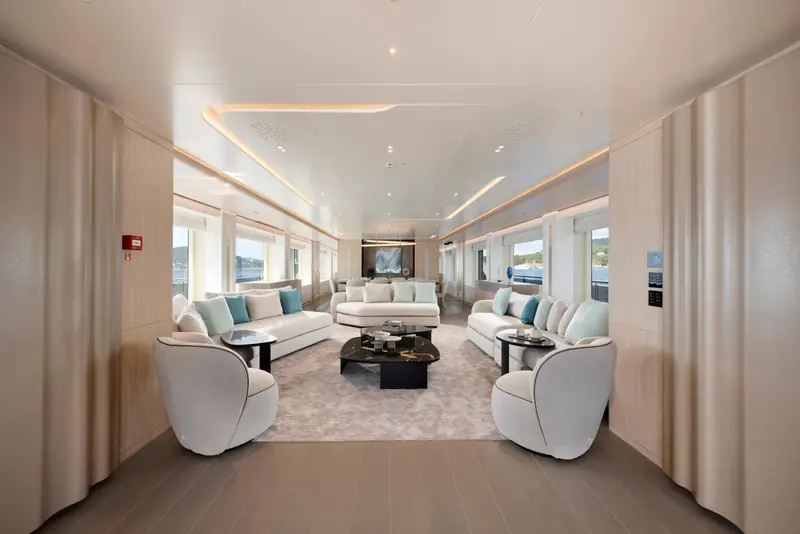 The main salon, split into two seating groups ahead of the dining table. Orion Yachts built the layout around how an owner actually uses the space, not a brochure floor plan.