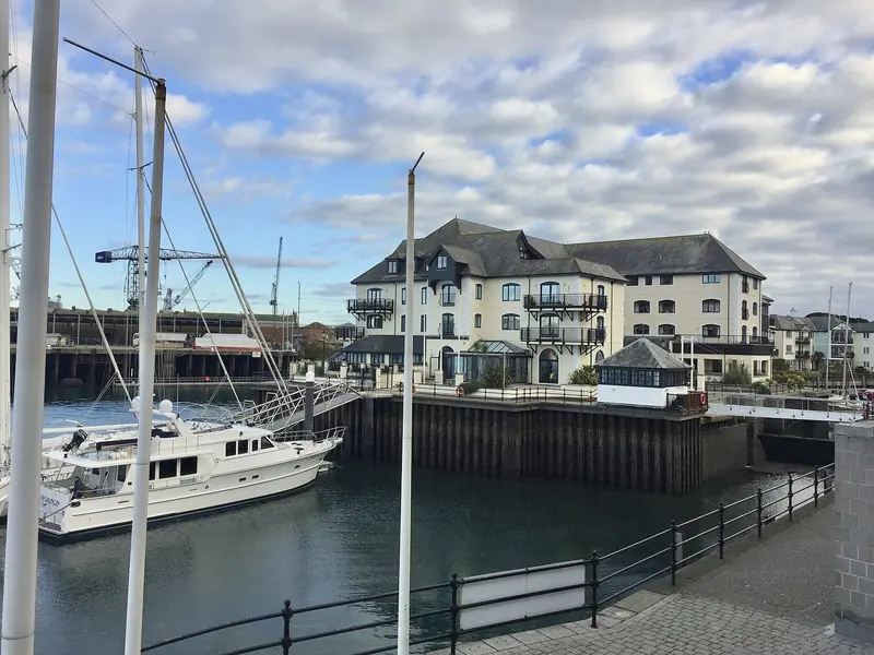 A yacht lying off the Falmouth quays. Pendennis takes alongside berthing up to 100 metres and refits to 85 metres LOA, so this is the size of water an owner is buying into rather than a Mediterranean superyacht marina.