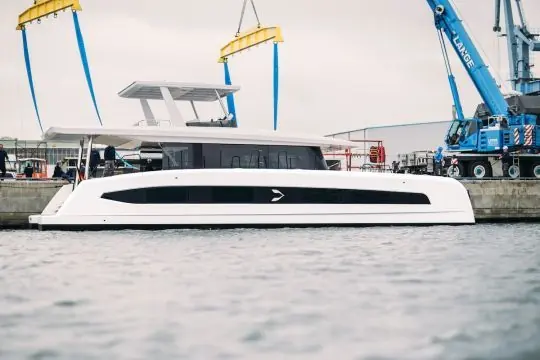 Pioneer One suspended in slings during her float-off at the Pioneer Yachts yard on Germany's Baltic coast.
