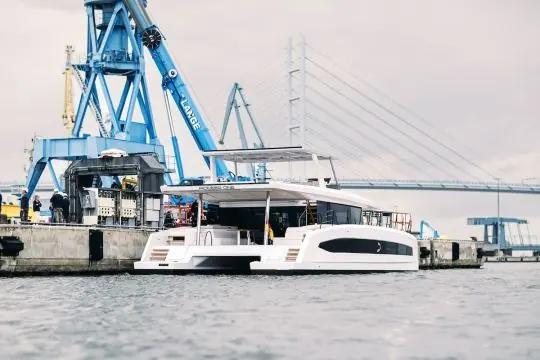 Pioneer One alongside the yard crane, with Stralsund's Rugen causeway bridge behind her.