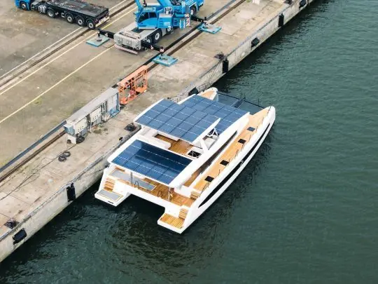 An aerial view of Pioneer One moored at Stralsund, showing the full extent of her coachroof solar panels.