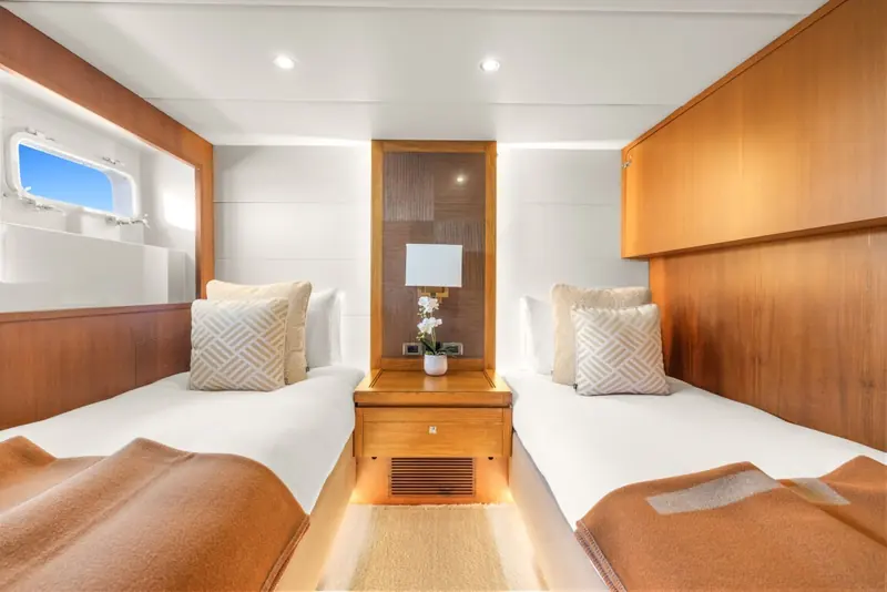 A twin guest cabin fitted with pullman-configurable berths, part of the five-cabin, 13-guest layout.
