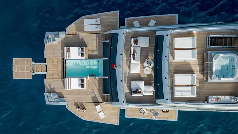 The deck plan from directly above: a pool aft on the lounge deck, a separate spa pool and hot tub further forward, and more than 370 square metres of open deck in total.