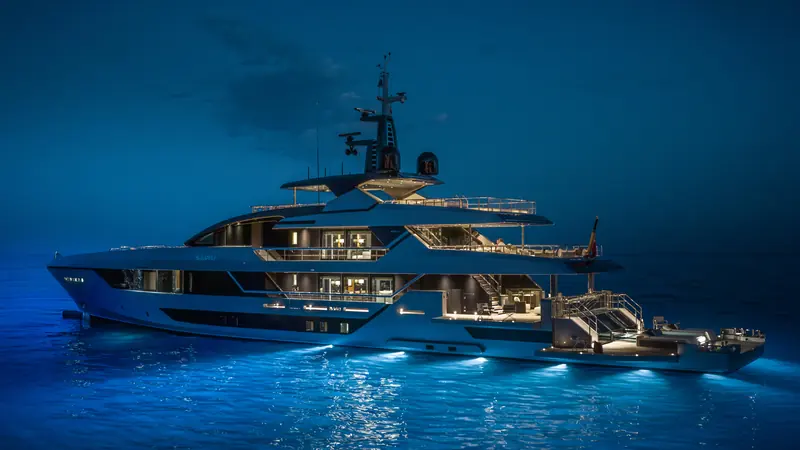 At anchor after dark. Twin MTU 12V2000 M96L diesels give her an 18-knot top speed and a 3,600-nautical-mile range at 11 knots.