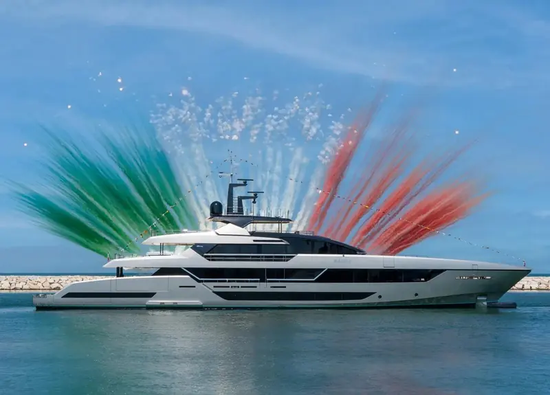 Sairu's christening, tricolour smoke either side of the hull at the yard where Riva's superyacht line is built.