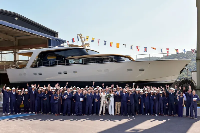 The Ameglia workforce turns out for the traditional launch photograph, godparents at the centre. Five of these had already been sold before anyone outside the yard had seen the boat.