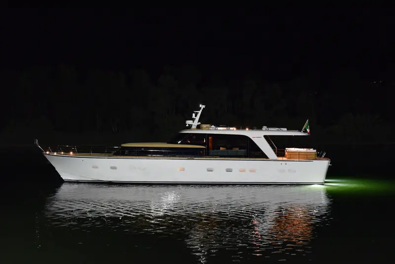 The full profile on launch night: a raked bow, a low wheelhouse and continuous glazing that Zuccon International Project drew to read as one unbroken line, not stacked decks.