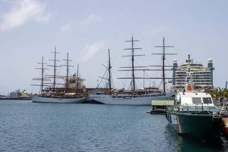 Sea Cloud moored alongside a fleet-mate at Las Palmas, dwarfed by a modern cruise ship behind - a reminder of how small a 1931 flagship now reads.