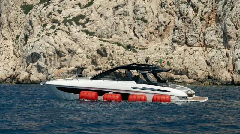 The same motoryacht from the side: the airbags sit low on the hull, clear of the waterline until triggered.