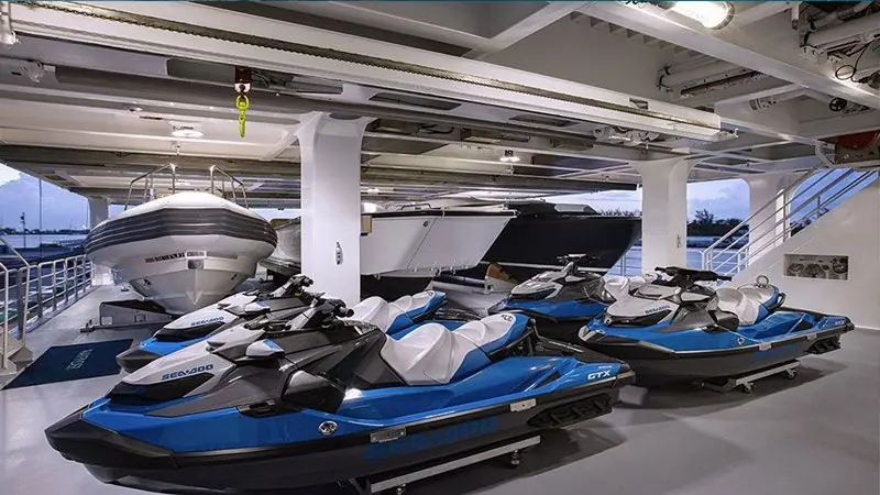 Wayfinder's garage, four jet skis and a RIB under a full-beam crane, the kind of toy capacity a Foundation Series buyer is paying for.