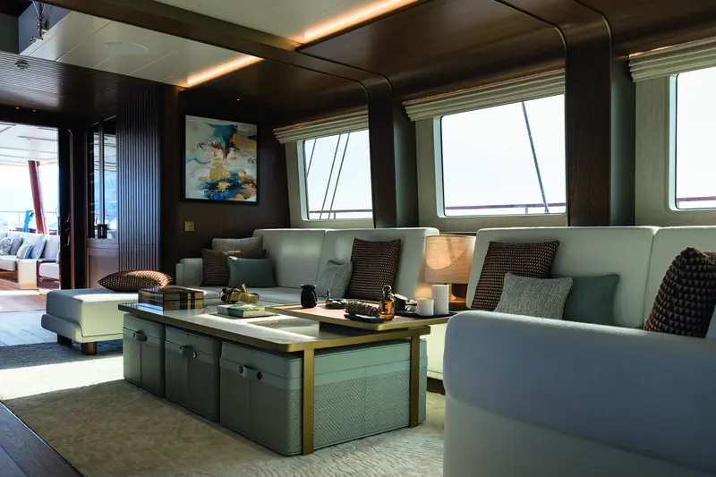 The lounge seating area, with the companionway to the aft deck visible at left. Simena is classed RINA Charter Class C.