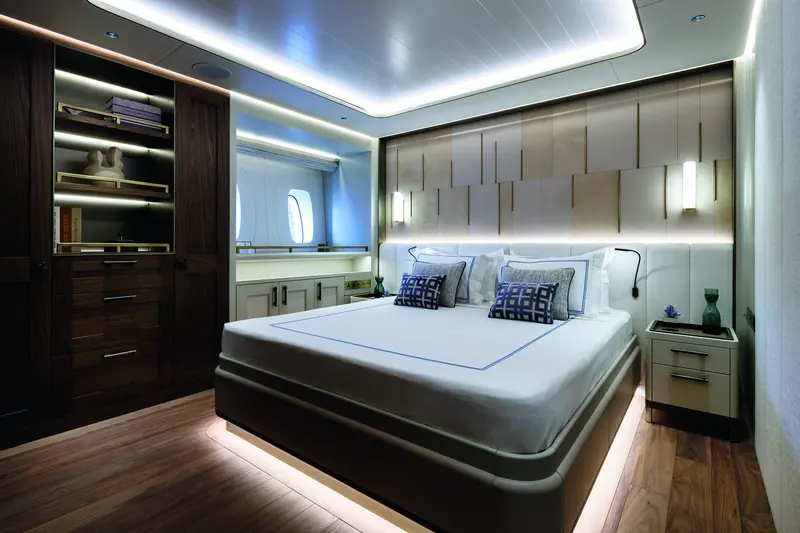 One of the guest cabins, with a private study nook framed by the hull's portholes.