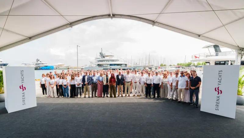 Sirena Yachts staff and guests at the 118's launch ceremony, the yacht at the quay behind them.