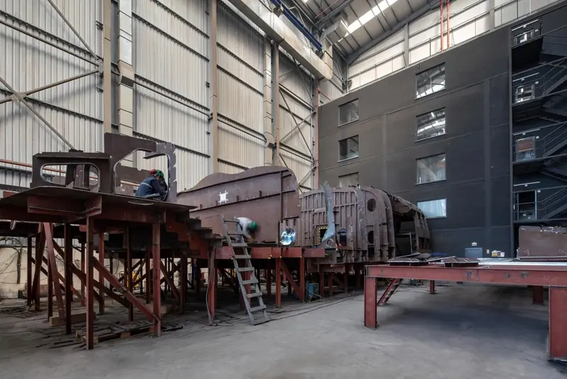 Fabrication tables and cut steel sections on the shop floor, part of the plant Sirena runs some 25 minutes inland from the coast.