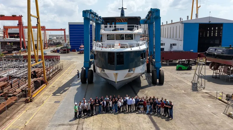 The build and launch team pose in front of the hull before the ceremony - the group a semi-custom yard the size of Soyaslan puts behind a genuine first-of-series.