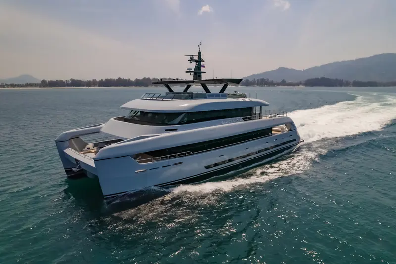 SpaceCat underway - the 35.9-metre catamaran's running shot shows the wide, shallow-draft hull that gave The White Lotus its unmistakable yacht silhouette.