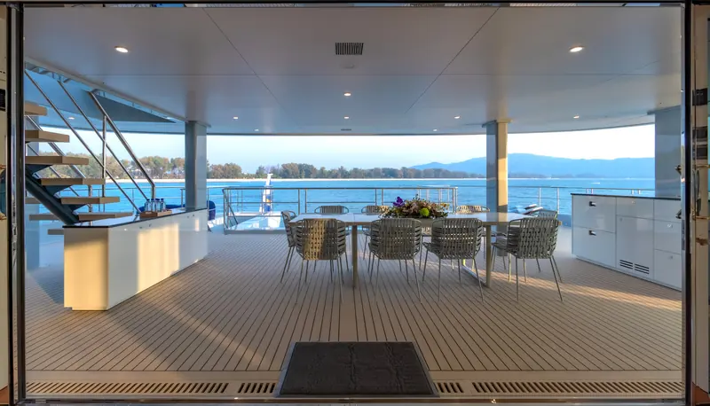 The aft deck dining area, part of the more than 534 square metres of interior and deck living space the catamaran hull makes possible.