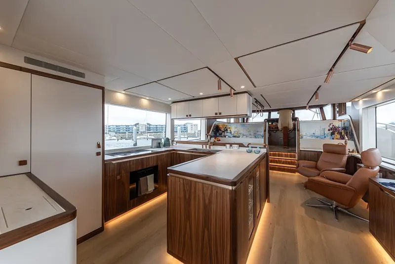 The full-beam galley and saloon on the single-side-deck main deck - the interior volume Steeler's asymmetric layout was built to reclaim.