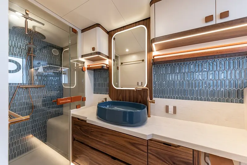 One of Nikitoo's three bathrooms, finished in walnut and blue-glazed tile.