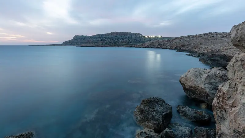 The coastline near Cape Greco at dusk; the anchorage where the boats were lost sits fully open to the sea, with little natural shelter.