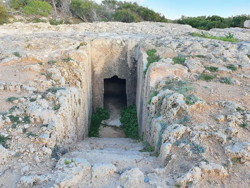A sea cave cut into the Cape Greco cliffs, part of the exposed coastline along Cyprus's southeastern point.