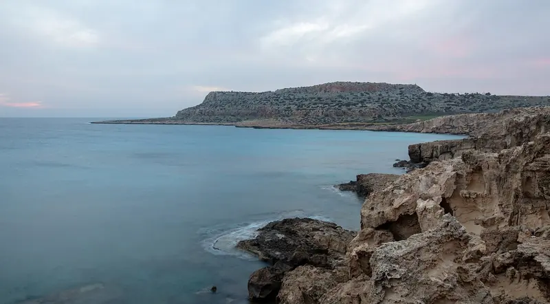 The Cape Greco coast at last light; Cyprus has no formal rule restricting a yacht from staying at anchor once a storm warning is issued.