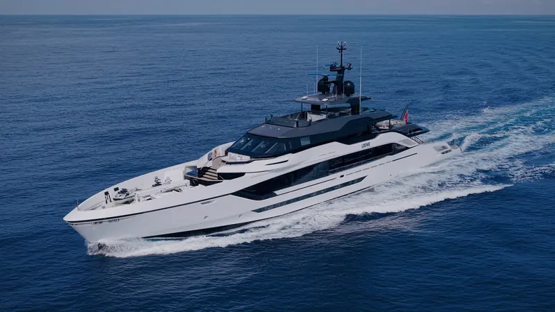 An aerial pass shows the full-beam owner's suite forward on the main deck and the sundeck spa pool aft.