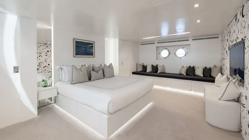 One of Moonshot's guest cabins, finished in white with a starlit accent wall and a private lounge area.