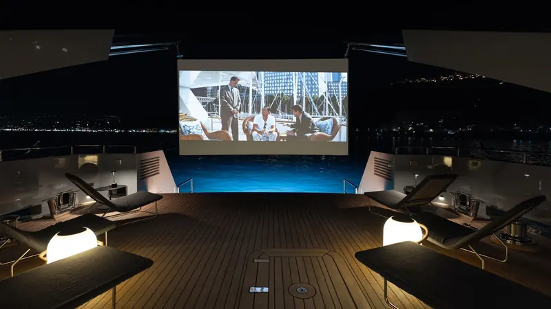 An outdoor cinema screen rigged on the aft deck for a film night at anchor.
