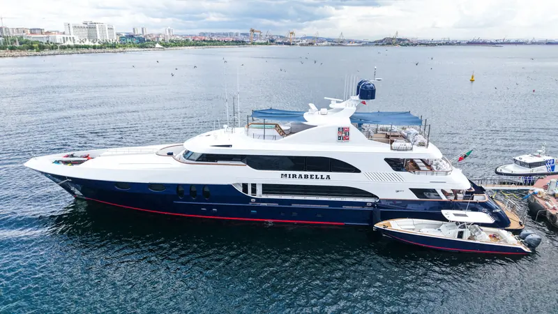 The 47.9-metre hull and her tender, freshly repainted. The refit stripped and repainted the hull and superstructure in a climate-controlled shed rather than touching up in place.