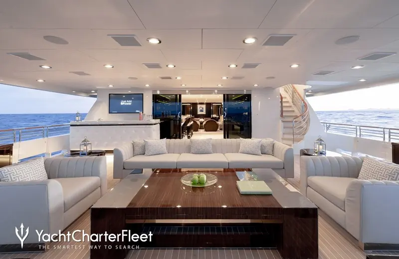 The main deck saloon, its pale upholstery a deliberate contrast against the dark joinery used elsewhere on board.