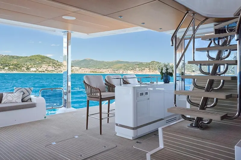 The aft deck wet bar and stairwell, with the galley to bar service point Atraversia's crew of four work from underway.