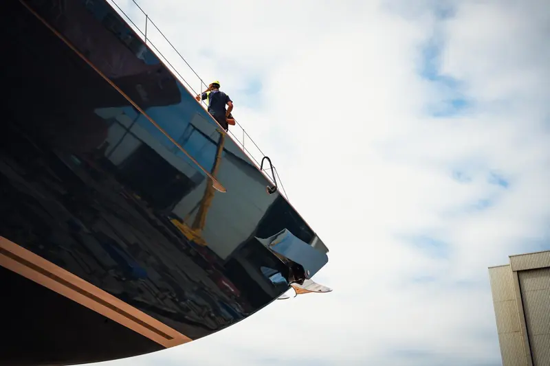 A Vitters rigger walks the foredeck as Zero is towed out. The masts and the 250kW hydrogeneration pods that do the real work were fitted after this tow-out, ahead of sea trials.