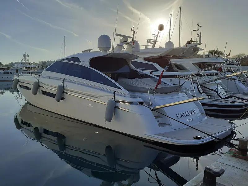 A flybridge motor yacht moored in Antibes harbour, the kind of boat routinely listed, relisted and re-priced as central agencies change.