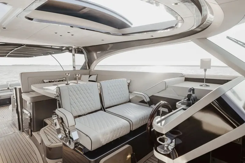 The salon looking aft. The quilted upholstery and the curved timber are done to a bespoke standard, and every hull leaves Groot-Ammers with an interior specified by its owner.