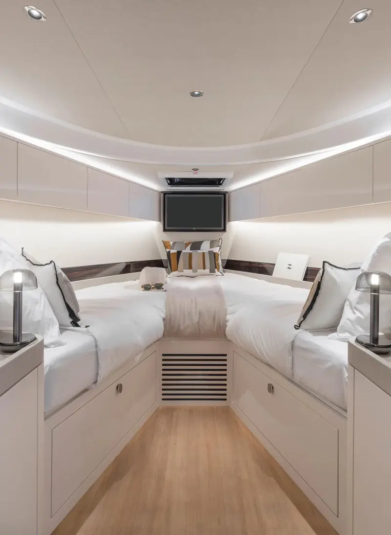 The forward guest cabin, twin berths that convert to a double. With the master, that is the whole of the accommodation: two cabins, four berths.