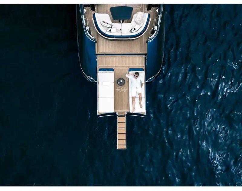 The folding transom down and the passarelle out. The beach club is the feature owners consistently name first, and the triple engine option removes the tender stowage that serves it.