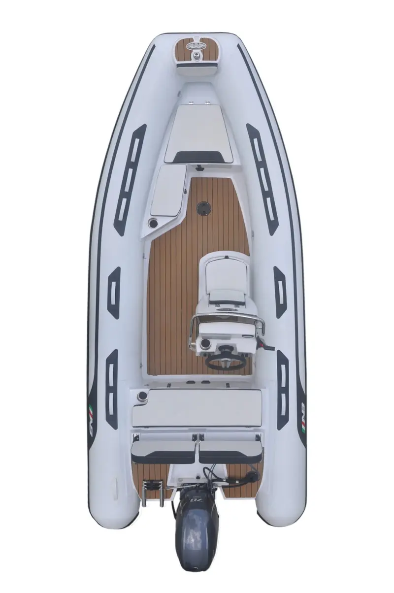 The AB Inflatables Alumina 15 ALX, an aluminium-hulled RIB tender, shown from directly overhead in the builder's studio photography, its teak-look sole and single outboard visible.