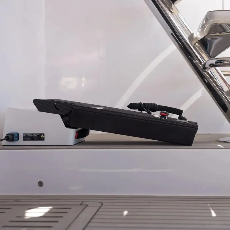 An Awake battery pack sits in its charger on the deck of a yacht.