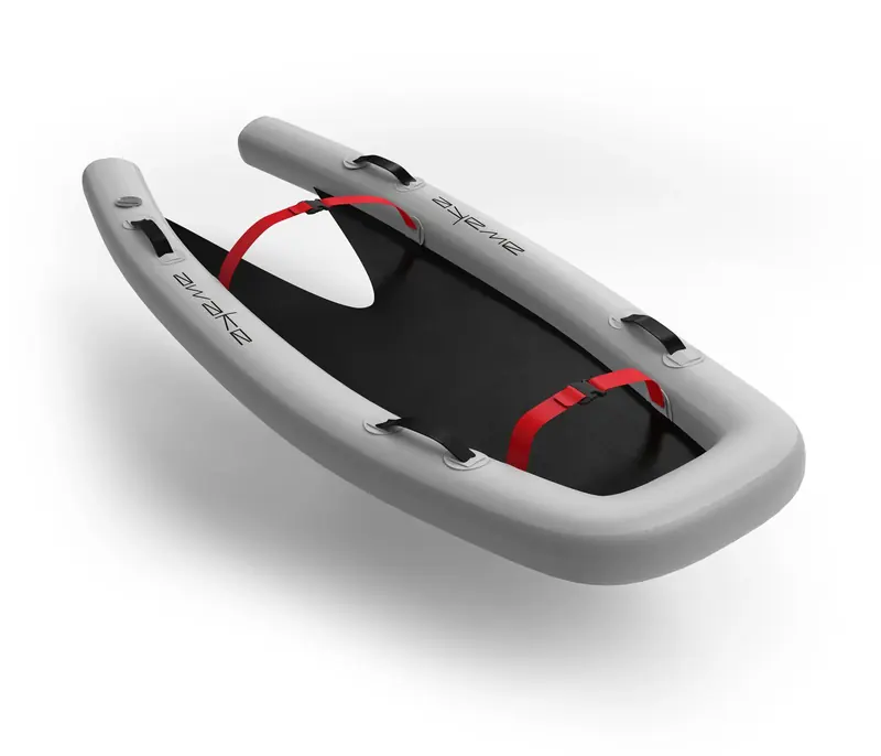 The Awake Vinga board itself, the inflatable hull open around a rigid black deck insert with red strap tie-downs fore and aft.