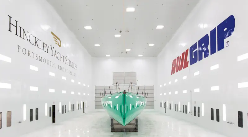 A freshly primed hull staged inside the Hinckley Yacht Services paint facility in Portsmouth, Rhode Island.