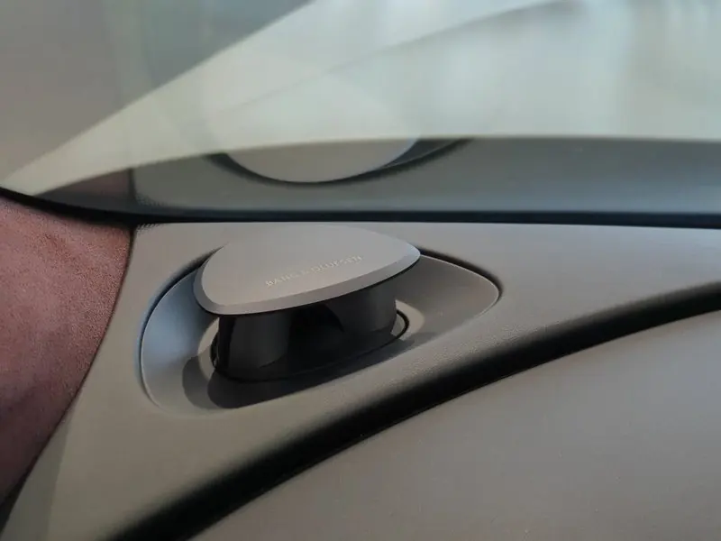 Rising from the dashboard, a Bang & Olufsen tweeter shows its brushed metal cap.