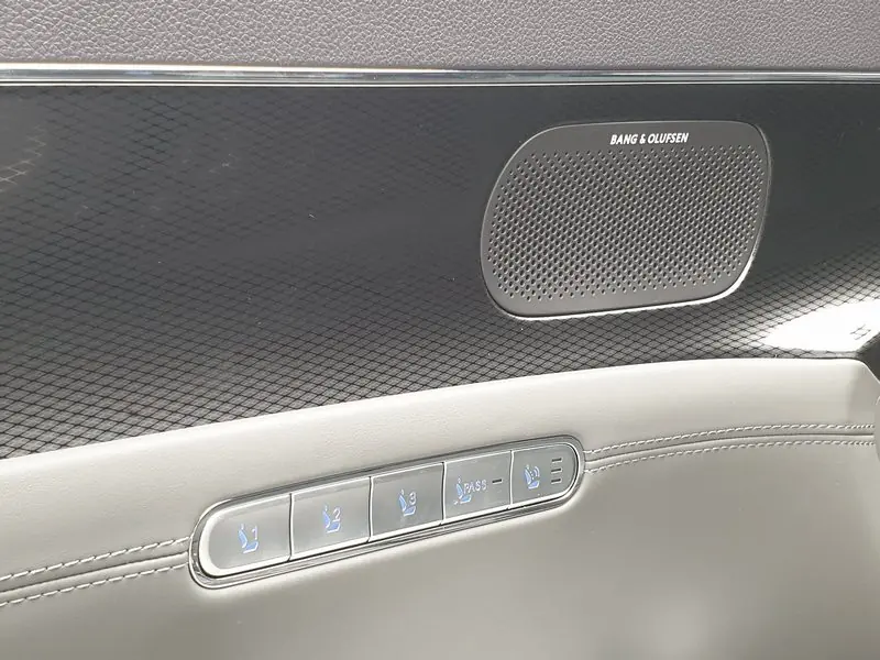 Seat memory buttons sit below a dark Bang & Olufsen speaker grille in a rear door.